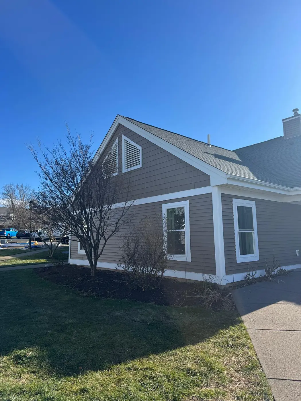 Cape style home with tan lap siding and white trim