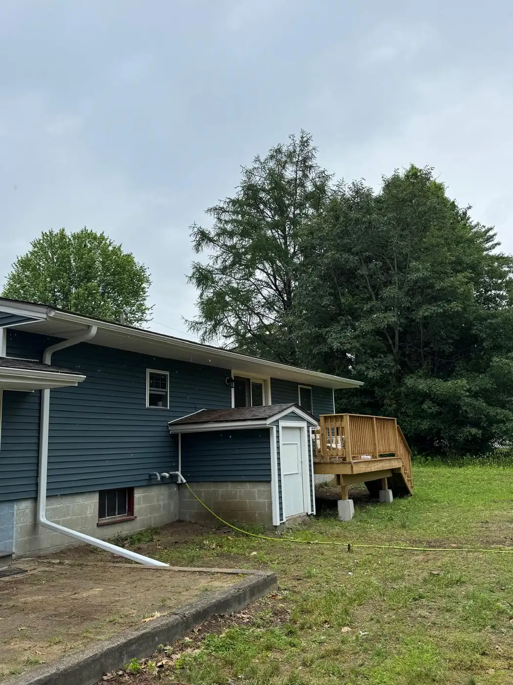 New gutter run and downspout on a completed exterior
